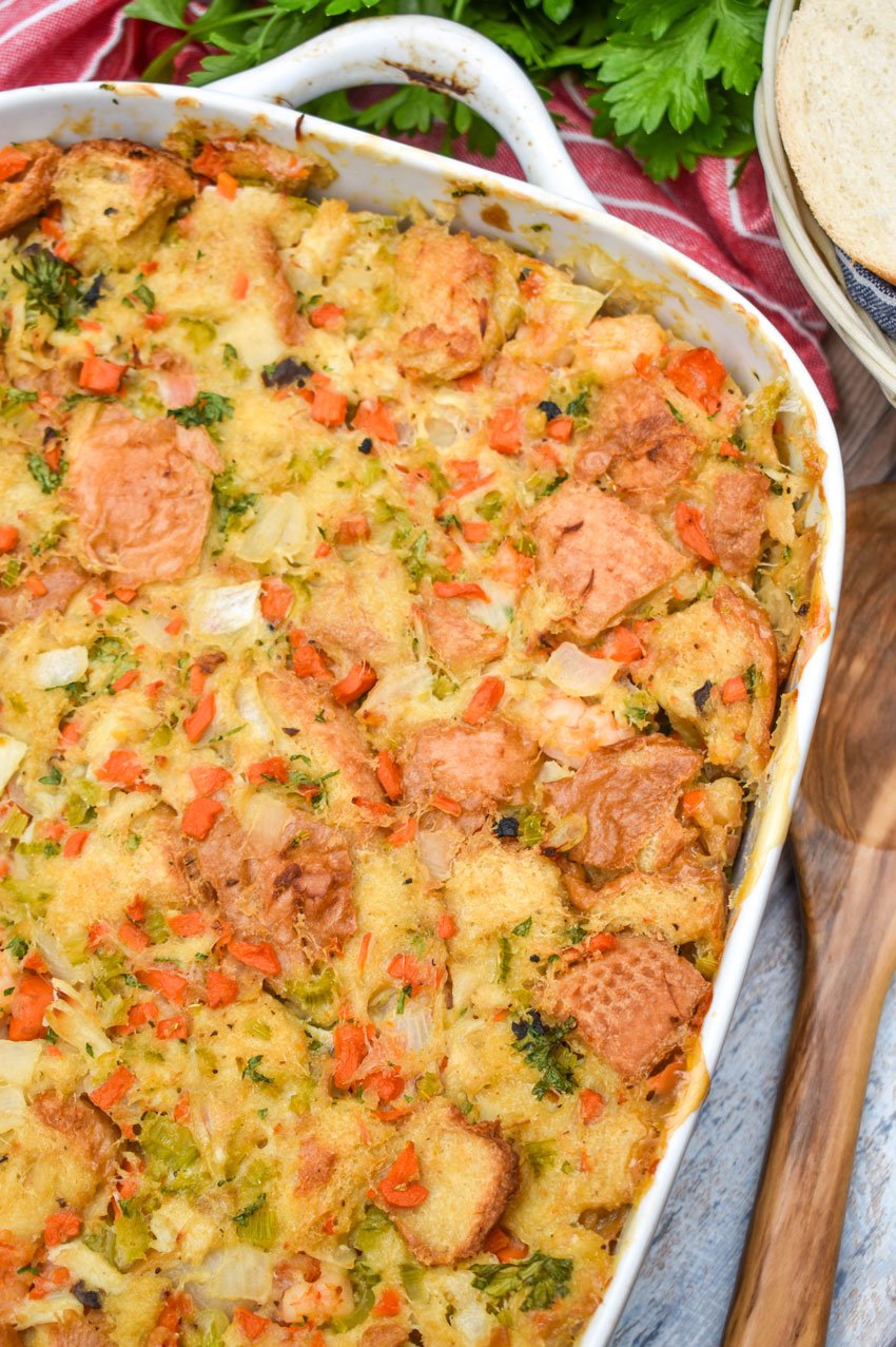 baked seafood stuffing in a white casserole dish