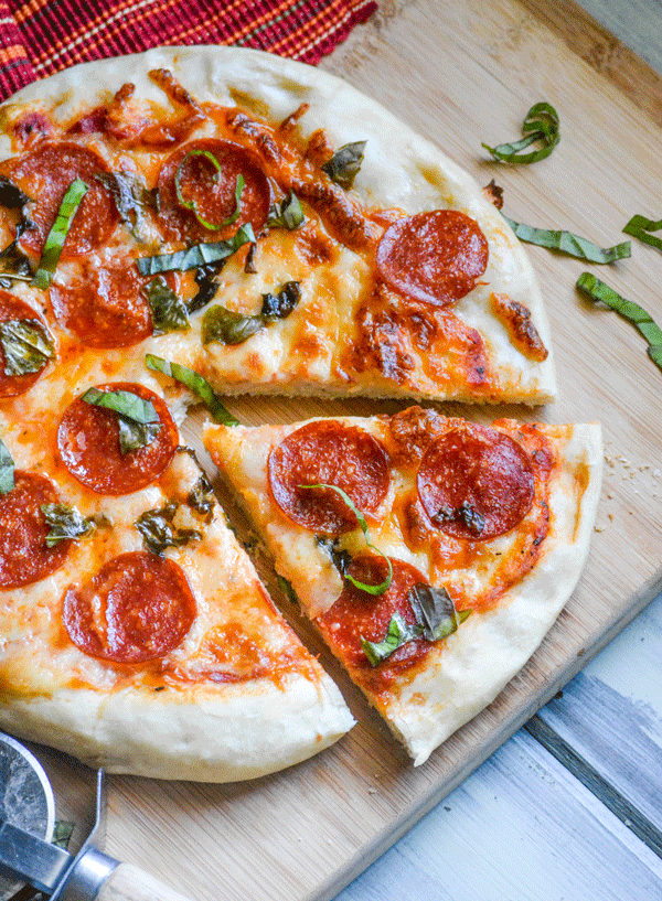 a slice cast iron pizza on a wooden cutting board