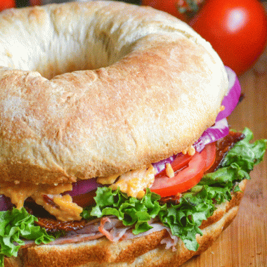 ham & pimento cheese bundt pan sub sandwich on a wooden cutting board