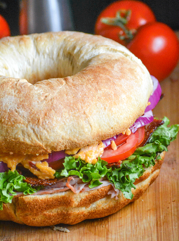 ham & pimento cheese bundt pan sub sandwich on a wooden cutting board