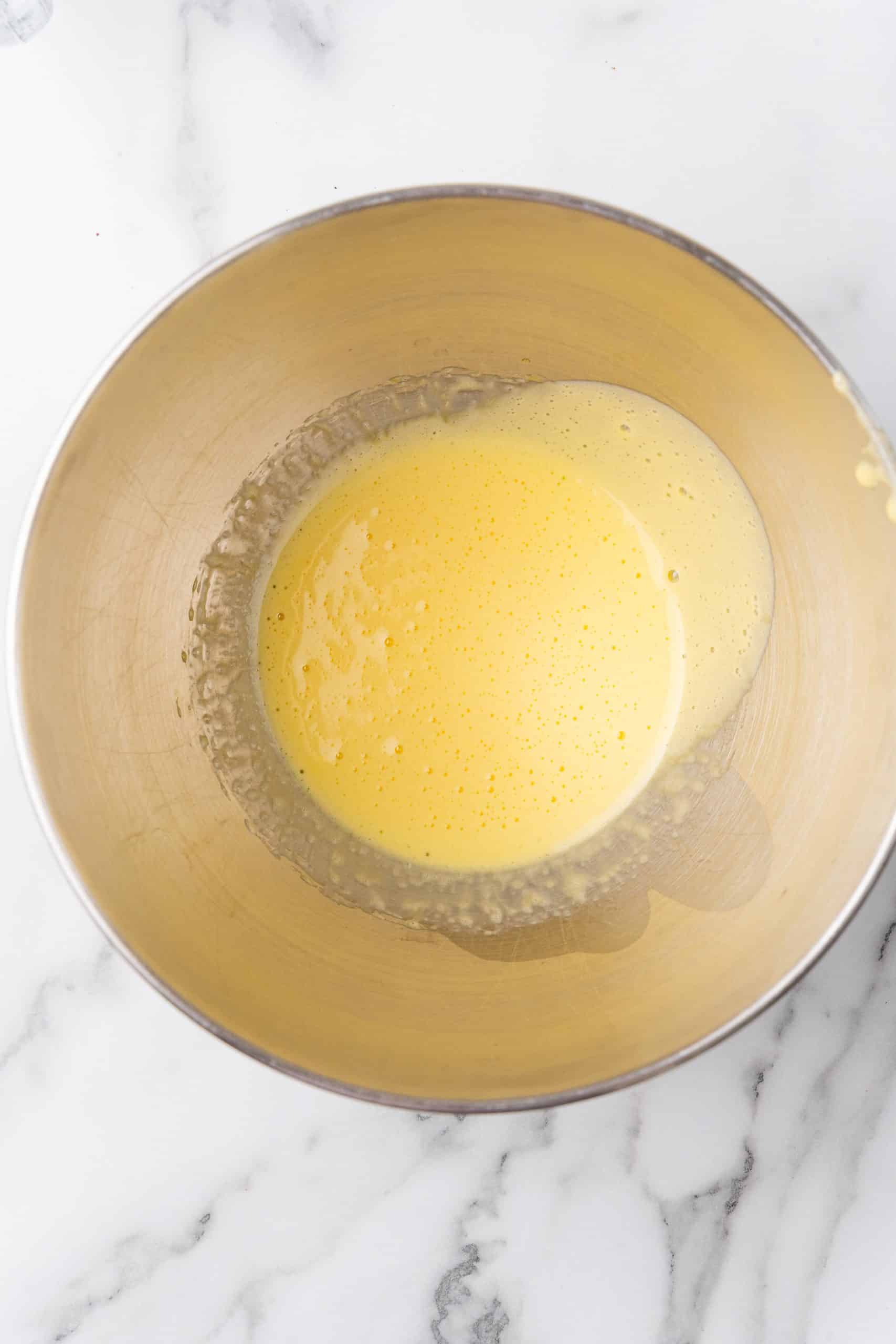 beaten eggs in a metal mixing bowl