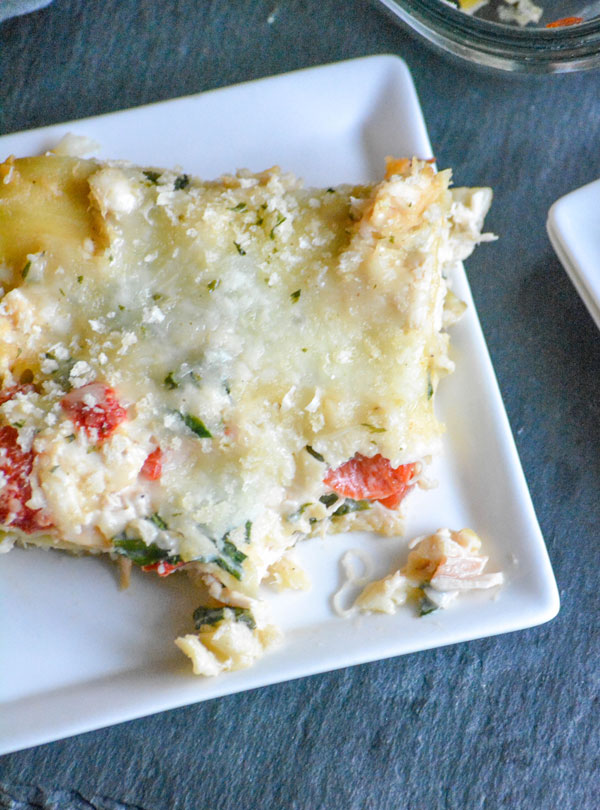 a slice of Chicken Caesar Lasagna shown on a white square plate