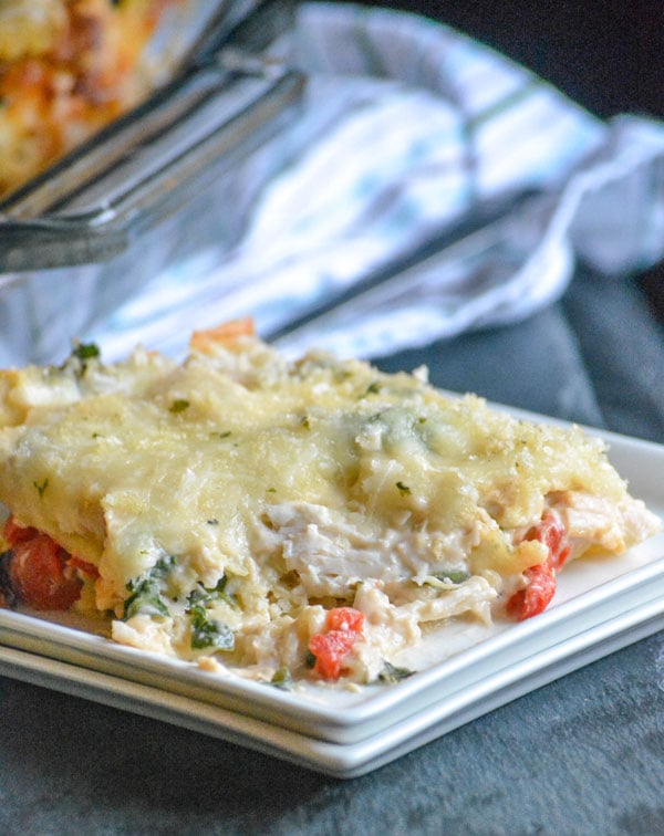 Chicken Caesar Lasagna shown served on a white square plate