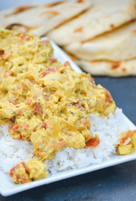 quick and easy chicken curry served over a bed of steamed white rice on a white platter