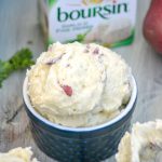 creamy boursin cheese whipped red potatoes in a blue ramekin