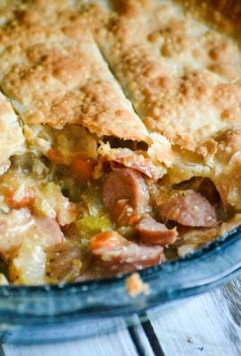 smoked sausage & chicken stuffed creole pot pie in a pale blue glass pie dish