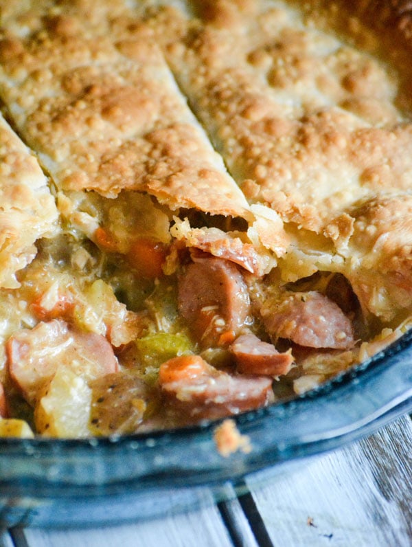 smoked sausage & chicken stuffed creole pot pie in a pale blue glass pie dish