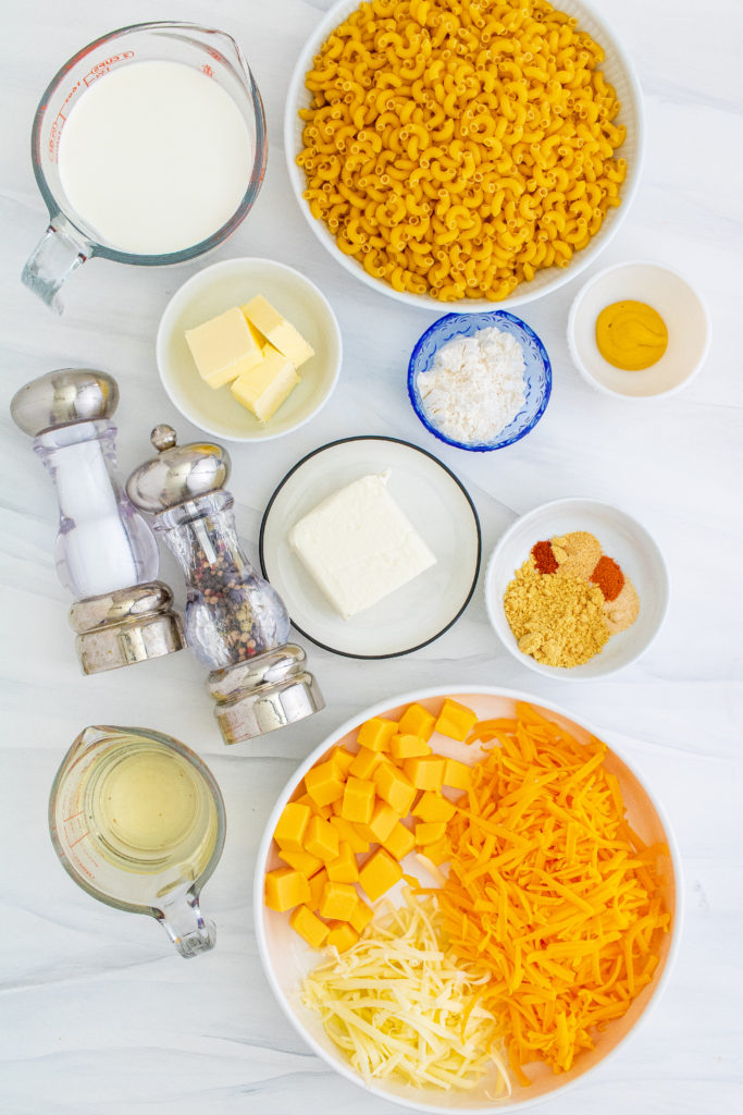 over head shot showing the ingredients needed to make smoked macaroni and cheese laid out on a marble countertop
