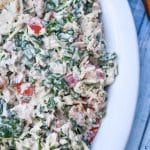 spinach and tomato tuna salad with greek yogurt in a white serving bowl