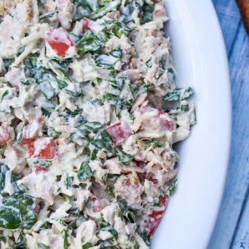 spinach and tomato tuna salad with greek yogurt in a white serving bowl