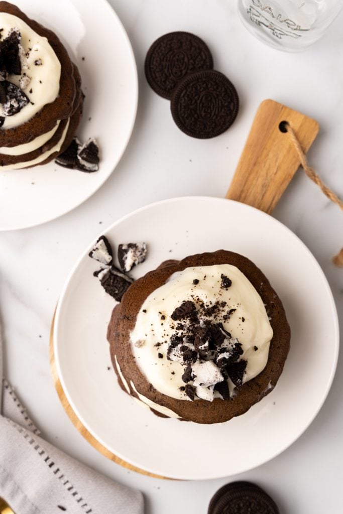 chocolate oreo flavored pancakes with fluffy frosting on white plates