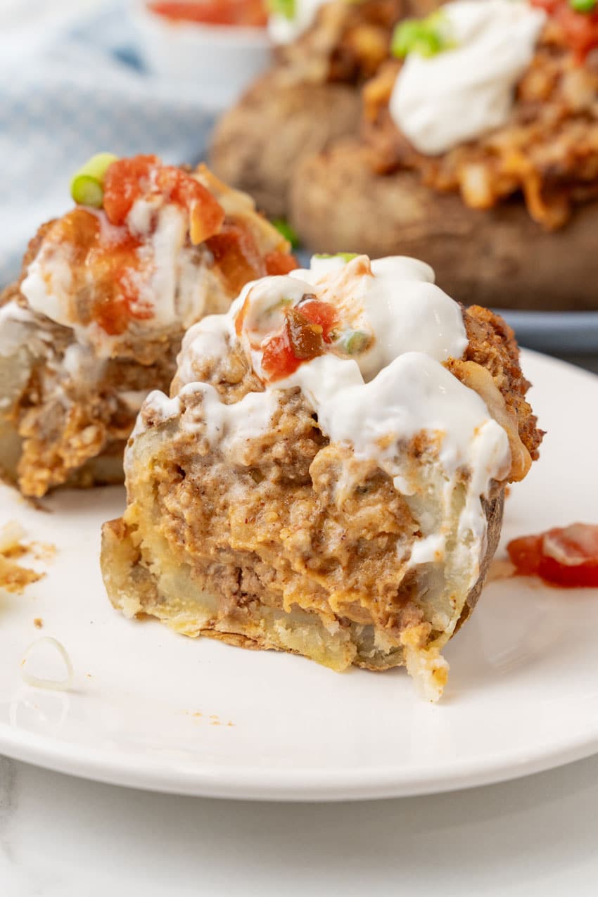 a twice baked loaded taco baked potato on a small white plate