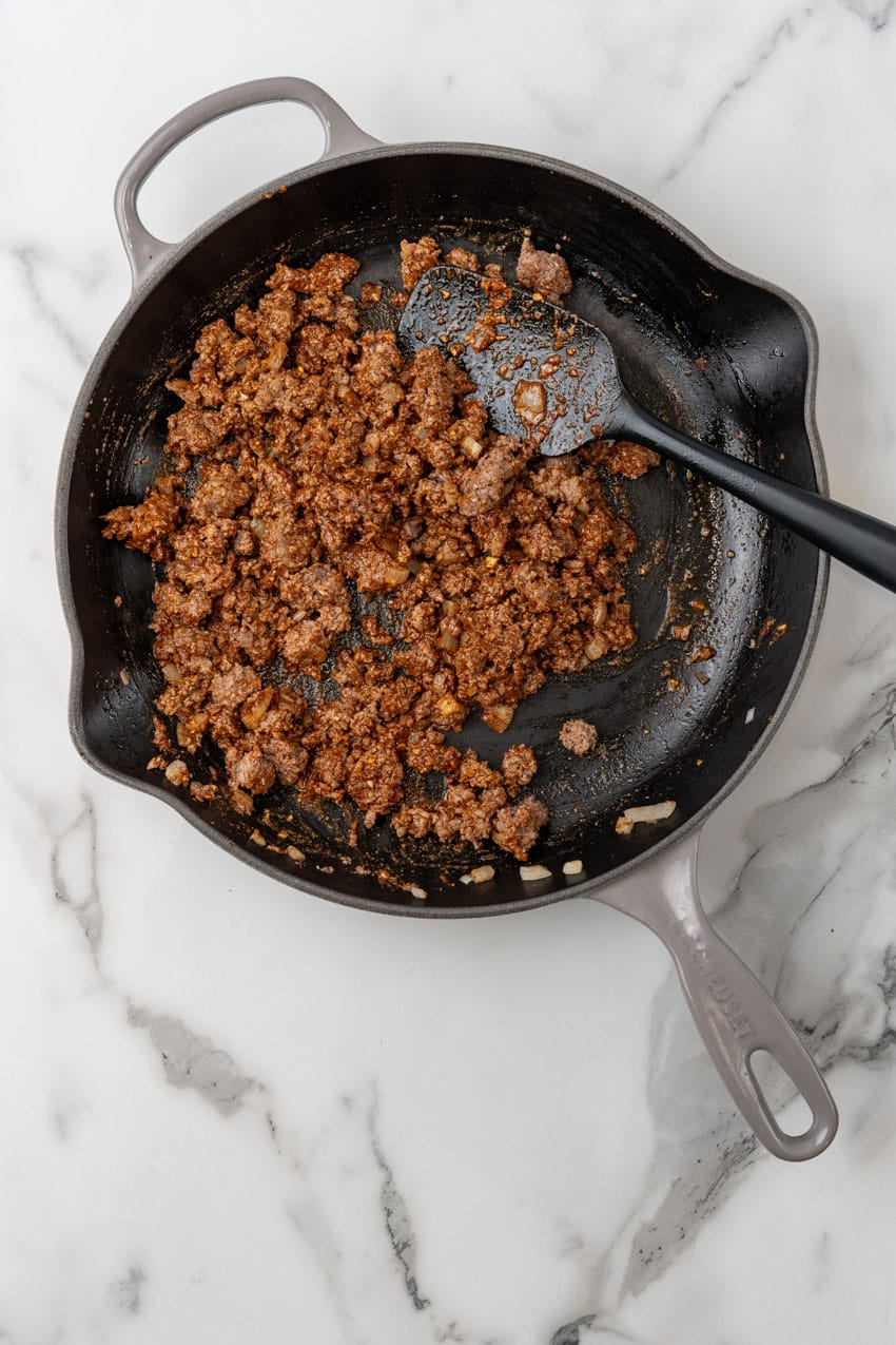 taco seasoned ground beef in a large cast iron skillet