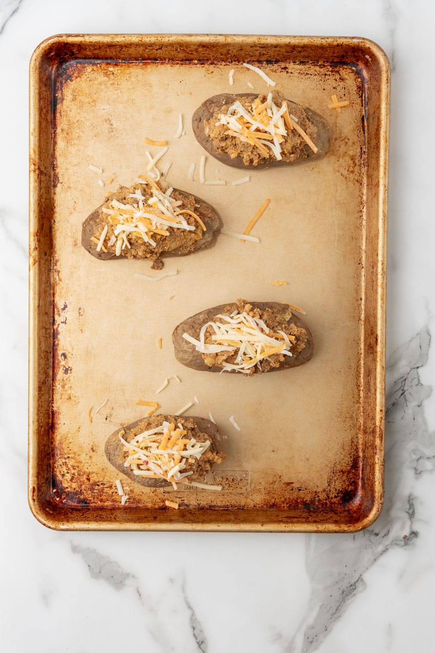 stuffed taco baked potatoes on a metal baking sheet