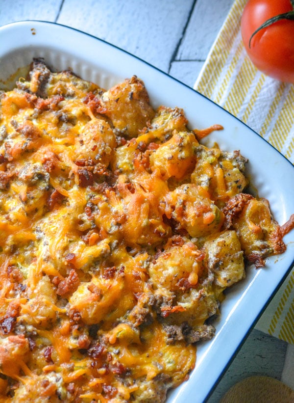 bacon cheeseburger tater tot casserole in a white baking dish