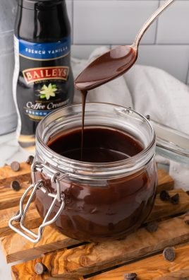 a silver spoon covered in Bailey's Irish cream chocolate sauce dripping into a glass jar