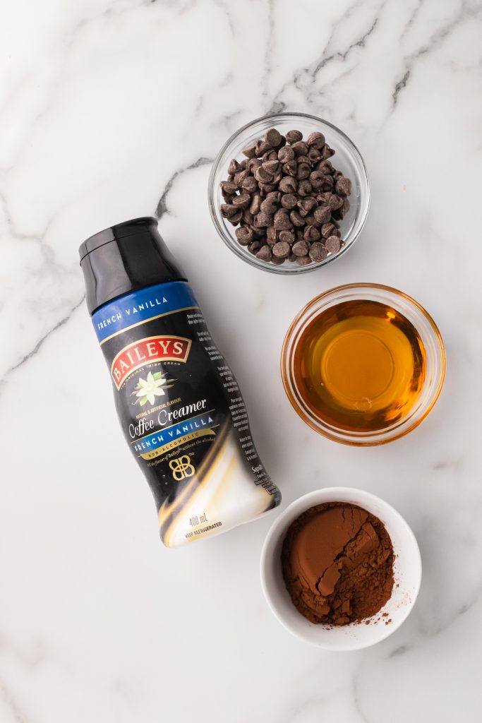 an overhead image showing the measured ingredients needed to make a batch of Bailey's Irish cream chocolate sauce