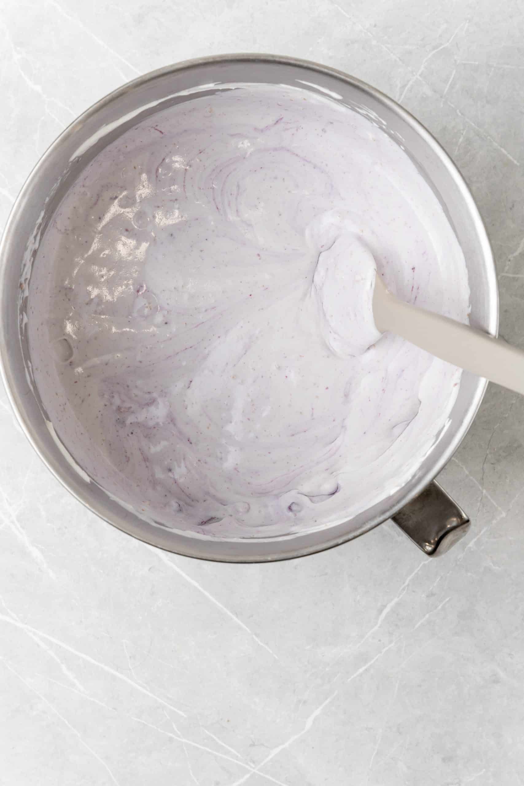 blueberry muffin ice cream base in a large metal mixing bowl