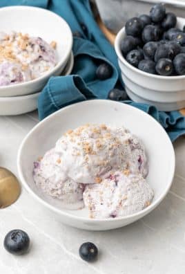 three scoops of no churn blueberry muffin ice cream in a white bowl