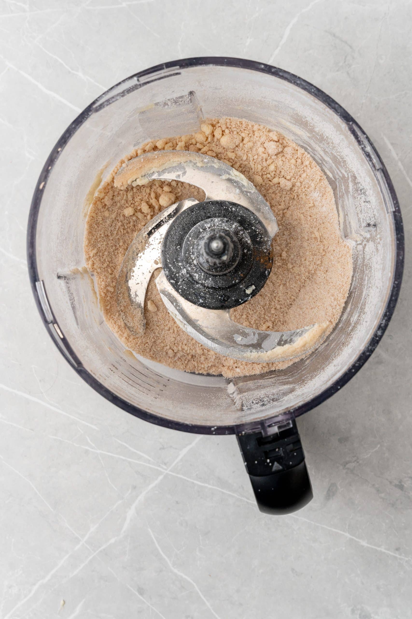 streusel dough in the bowl of a food processor fitted with the blade attachment 