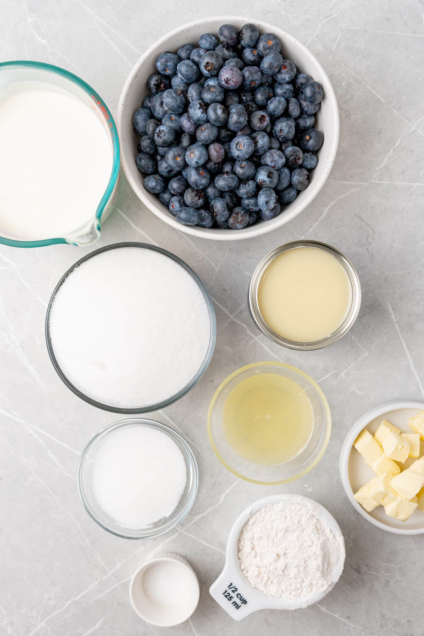 an overhead image showing the measured ingredients needed to make a batch of no churn blueberry muffin ice cream