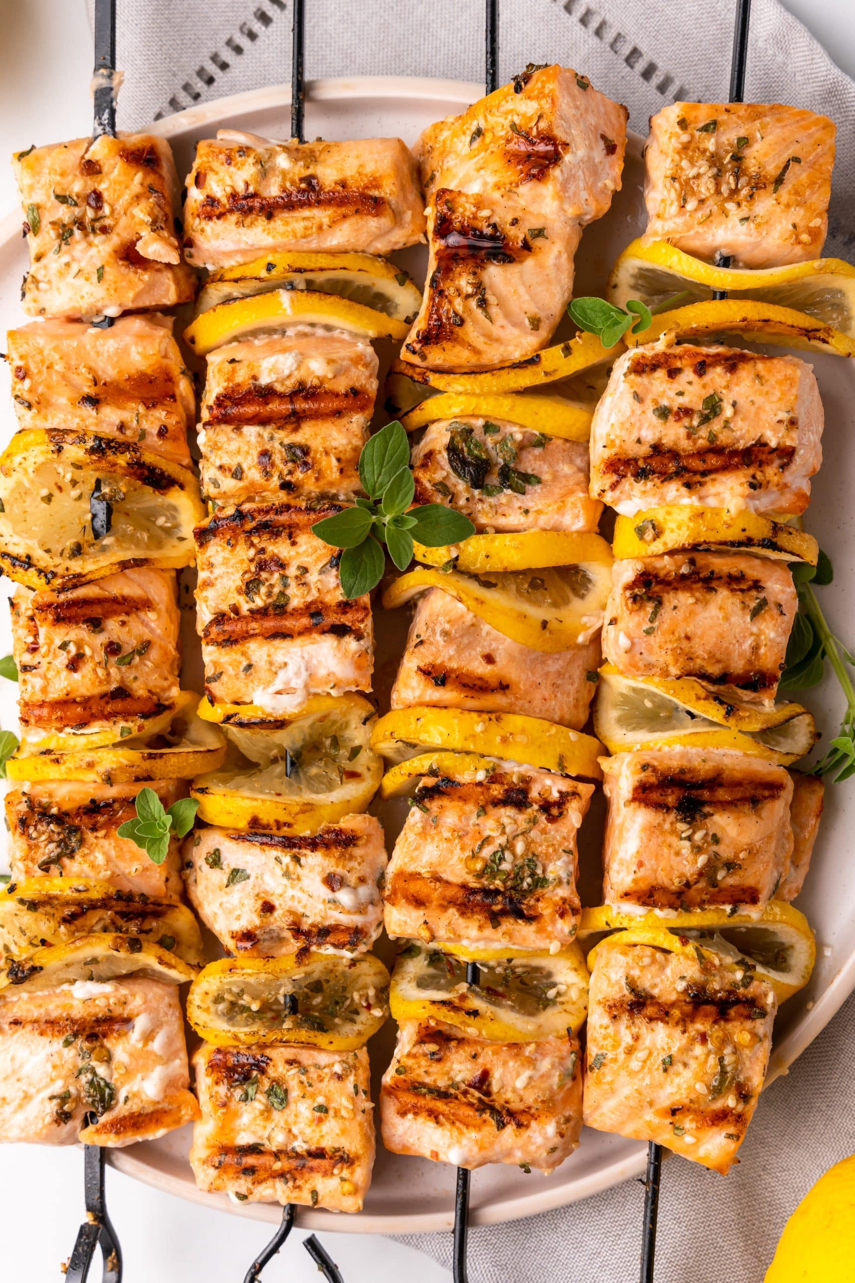 grilled lemon salmon skewers on a white plate