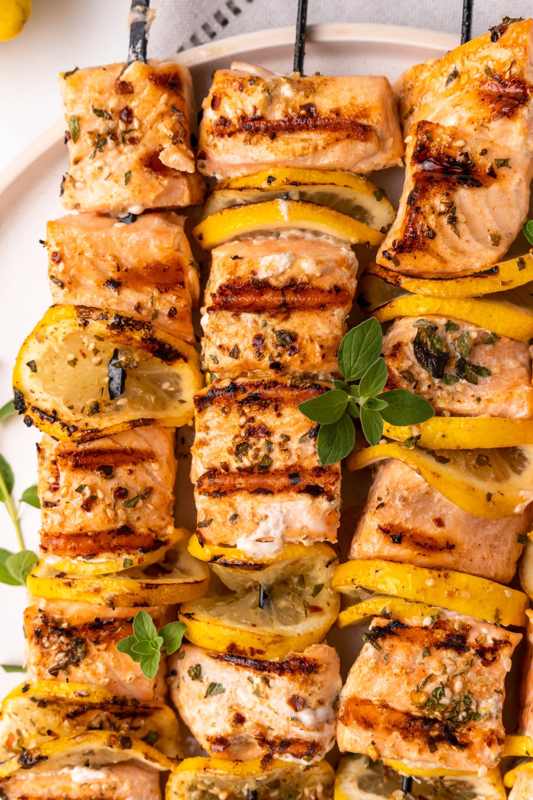 grilled lemon salmon skewers on a white plate