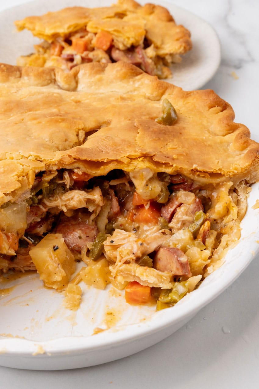 smoked sausage and chicken pot pie in a white pie plate
