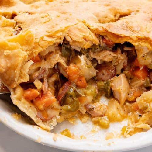 smoked sausage and chicken pot pie in a white pie plate