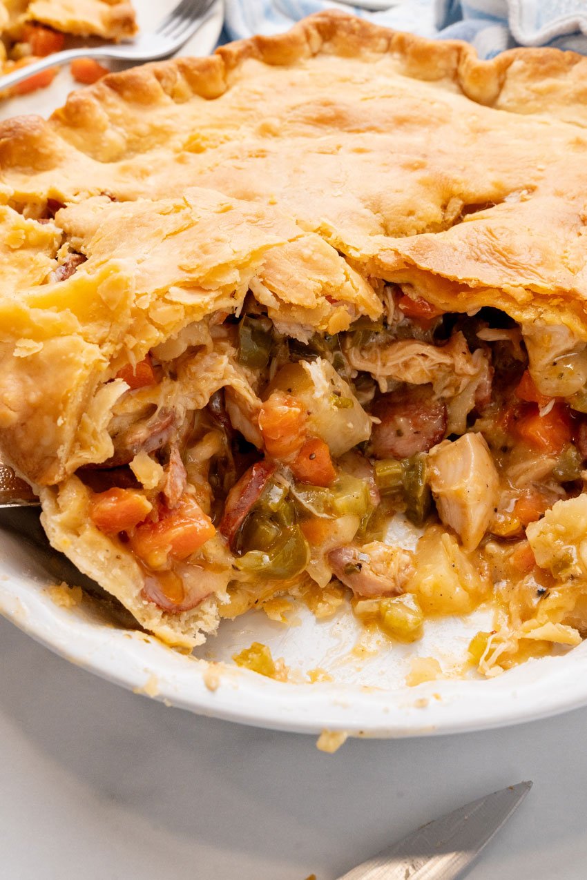 smoked sausage and chicken pot pie in a white pie plate