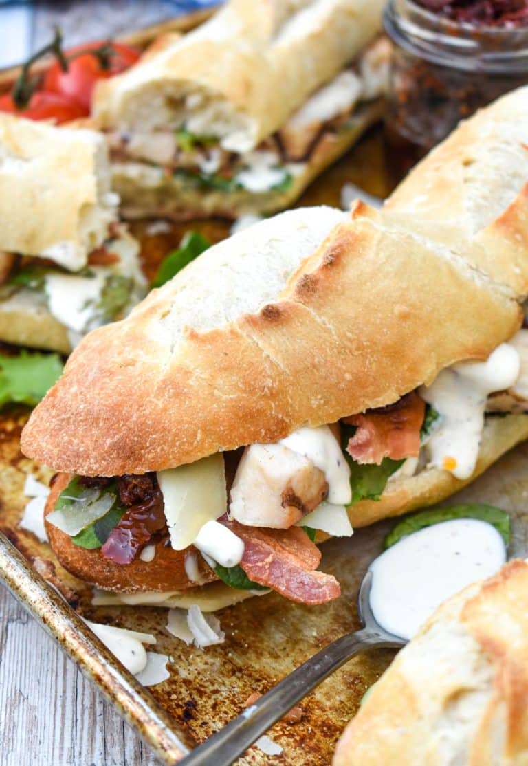 toasted chicken caesar club sub sandwich on a metal sheet pan