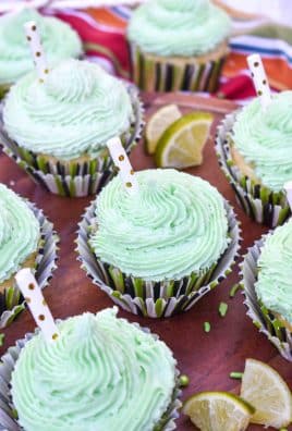 margarita cupcakes on a wooden cake stand
