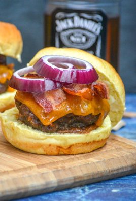 smoked whiskey bacon cheeseburger on a wooden cutting board