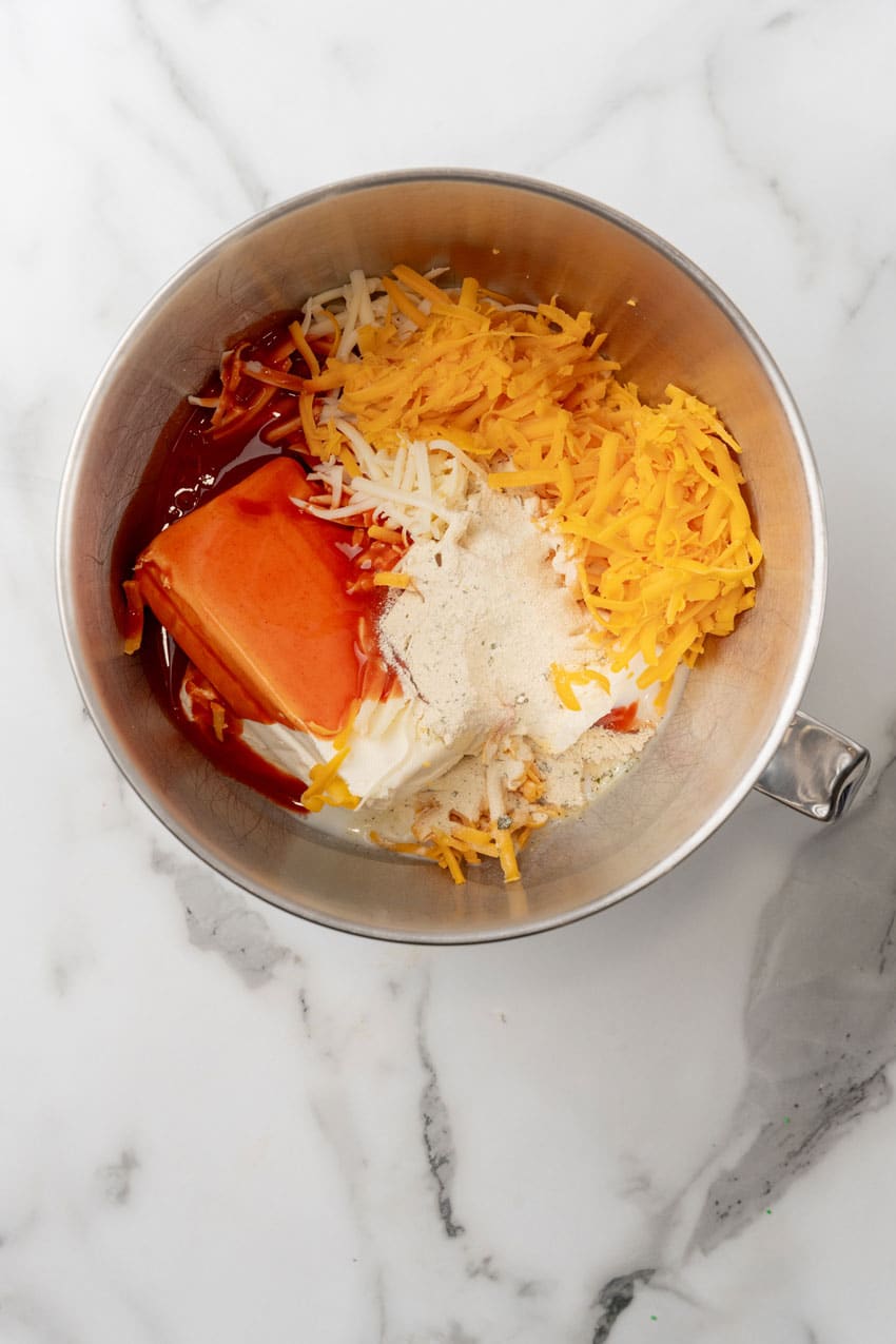 buffalo chicken lasagna filling ingredients in a large metal mixing bowl
