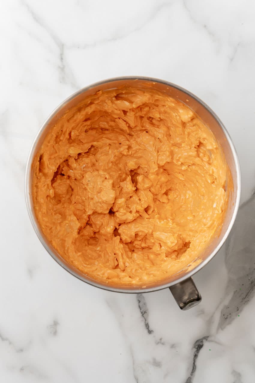 buffalo chicken lasagna filling mixture in a large metal mixing bowl