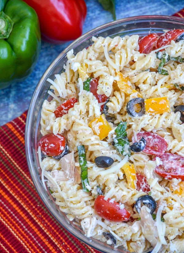 creamy Italian chicken pasta salad on a large glass mixing bowl