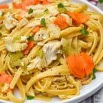 creamy chicken and vegetable pasta on a white plate