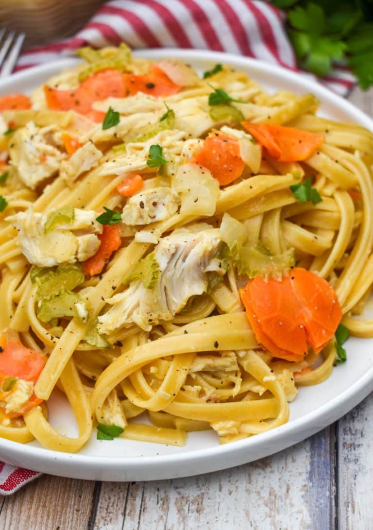 creamy chicken and vegetable pasta on a white plate