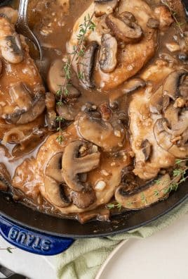 a close up of pork marsala in a cast iron skillet