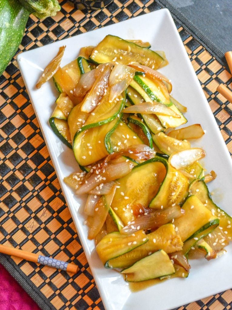 saucy, caramelized Japanese Steakhouse Hibachi Style Zucchini & Onions served on a white platter