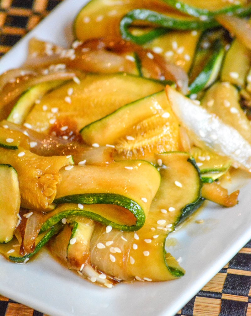 saucy, caramelized Japanese Steakhouse Hibachi Style Zucchini & Onions served on a white platter