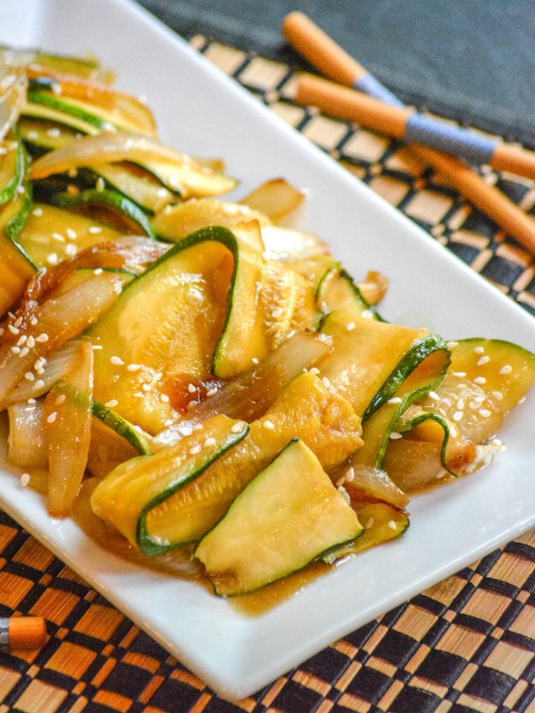 saucy, caramelized Japanese Steakhouse Hibachi Style Zucchini & Onions served on a white platter