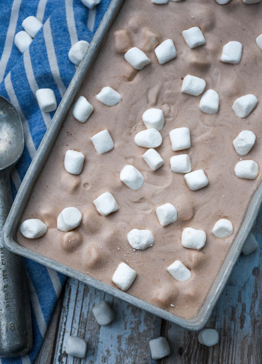 no churn hot chocolate ice cream topped with mini marshmallows in a metal loaf pan