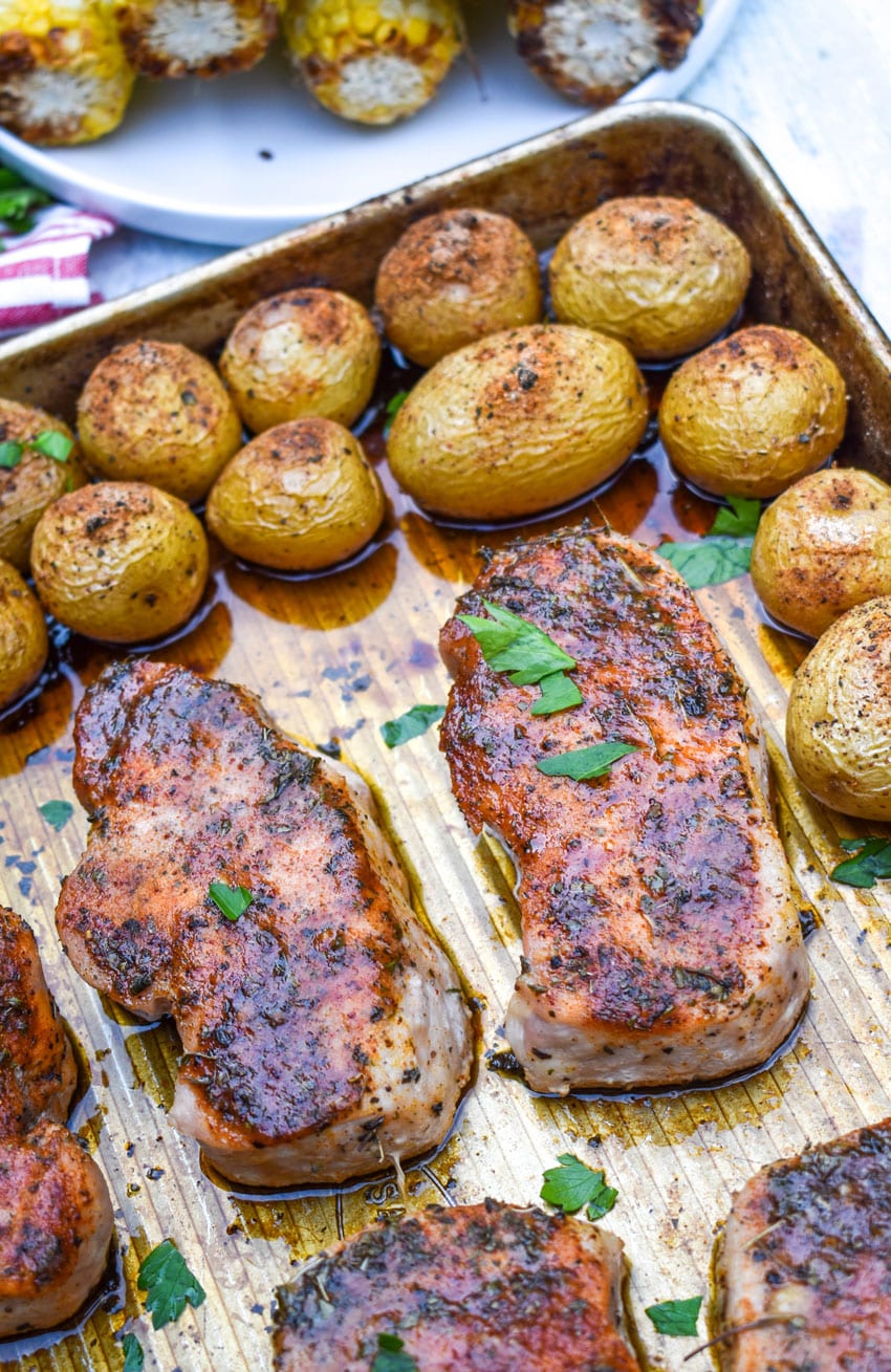 ranch pork chop sheet pan dinner on a metal baking sheet