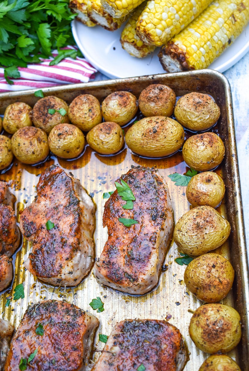 ranch pork chop sheet pan dinner on a metal baking sheet