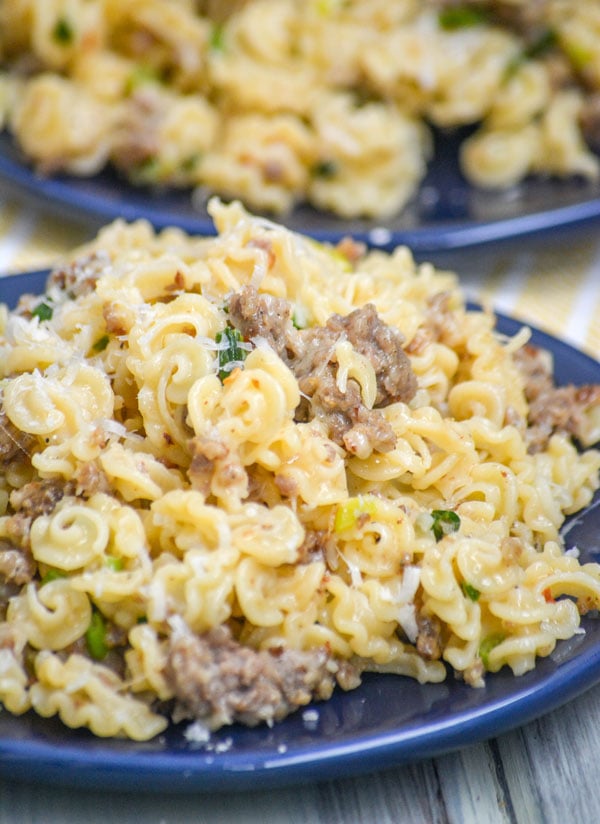 sausage & parmesan pasta skillet served on two blue plates