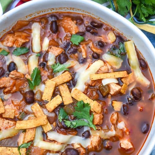 chicken and black bean soup in a large white bowl