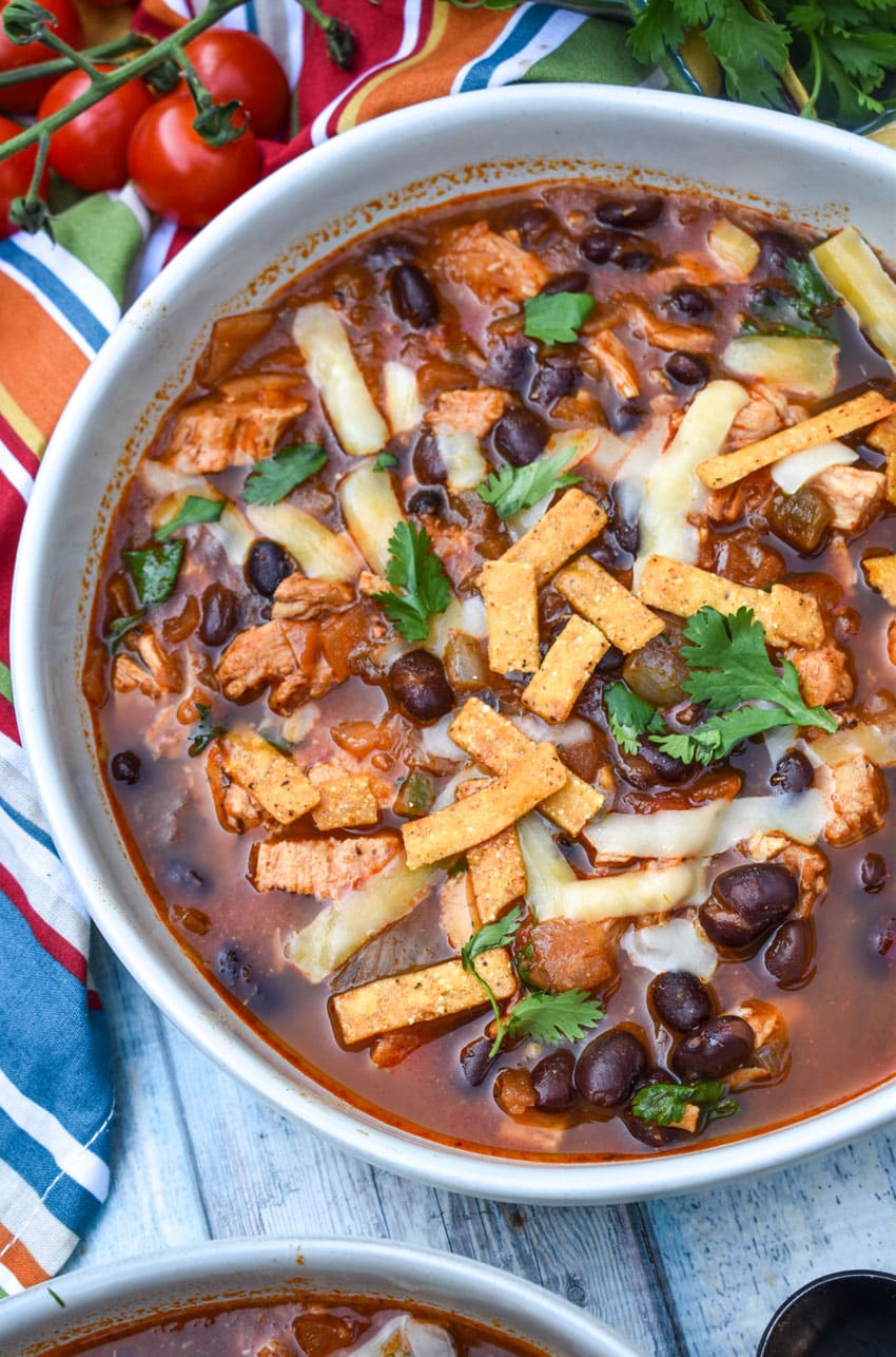 chicken and black bean soup in a large white bowl