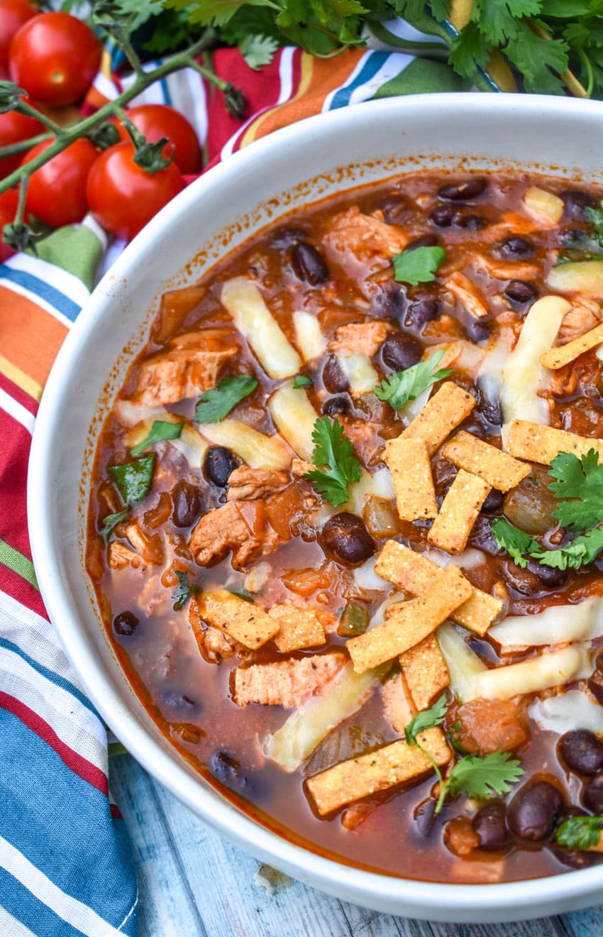 chicken and black bean soup in a large white bowl