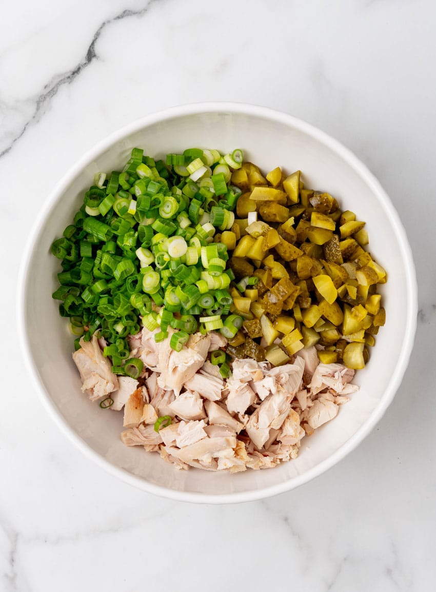 chopped chicken, pickles, and green onions in a large mixing bowl